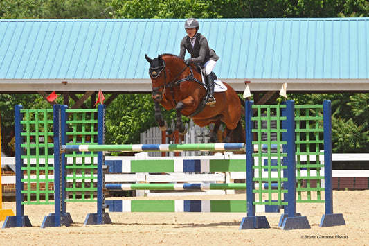 Lainey Ashker going over a jump on a horse for Hooflex Blog