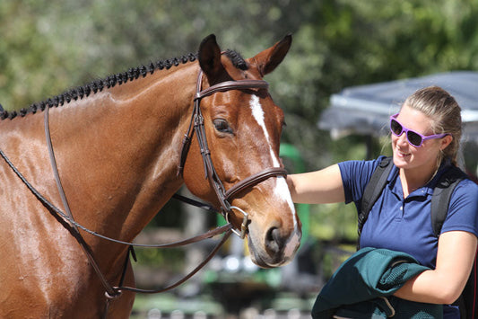 Groom petting a horse
