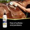 Woman sponge bathing her brown horse.  Showsheen 2 in 1 Shampoo and Conditioner free of sulfates and parabens.